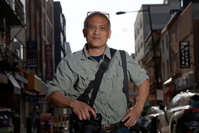 Photographer Rodney Atienza in the Chinatown section of Phila., Pa. he has been documenting for nearly three decades.