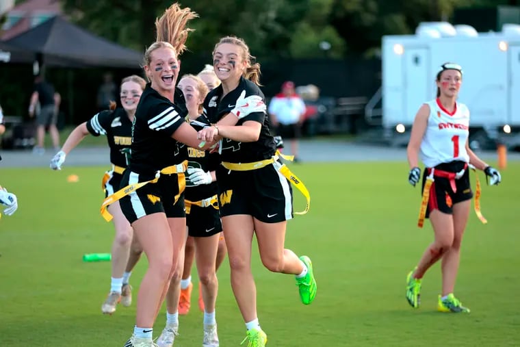 Lauren Greer, left, and Ava Renninger of Archbishop Wood celebrate after defeating Gwynedd Mercy in the Eagles’ Pennsylvania flag football championship at the Eagles Nova Care center on June 1, 2024.