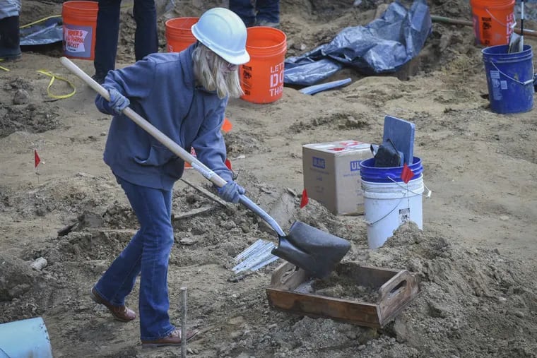 Volunteer archaeologists work to exhume bodies buried at the Former First Baptist burial ground on Wednesday afternoon, March 8, 2017