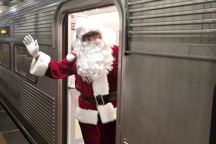 Santa Claus waves from the door of a PATCO train during the commuter railroad's annual 'Silver Sleigh' event for children. Specially decorated PATCO trains made several trips along the line between Lindenwold, N.J. and Center City Philadelphia.