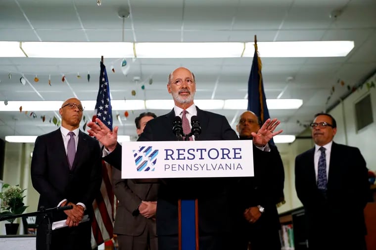 Pennsylvania Governor Tom Wolf speaks during a news conference at the John H. Taggart School library March 21 in Philadelphia. Wolf on Tuesday vetoed a bill that would have greatly expanded a tax credit program for donations to send Pennsylvania children to private schools.