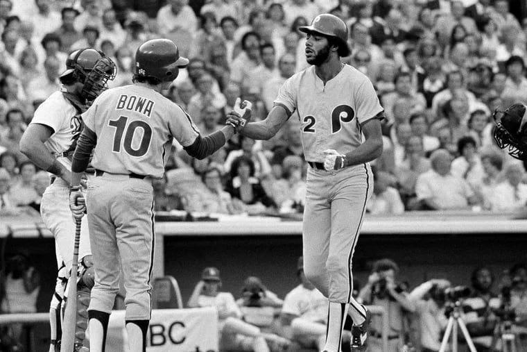 Phillies outfielder Bake McBride crossing home plate and being met by teammate Larry Bowa after hitting a home run against the Dodgers in the 1977 playoffs.