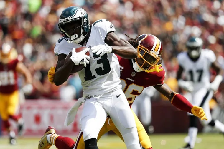 Eagles wide receiver Nelson Agholor runs with the football past Washington Redskins free safety D.J. Swearinger during the first-quarter on Sunday, September 10, 2017, Landover, MD. Agholor scored a touchdown on the play. DAVID MAIALETTI / Staff Photographer