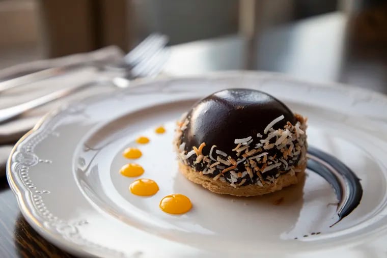 Among Restaurant Week desserts: A tropical chocolate mousse bombe with mango filling, brown butter blondie, and toasted coconuts at XIX Nineteen in Center City.