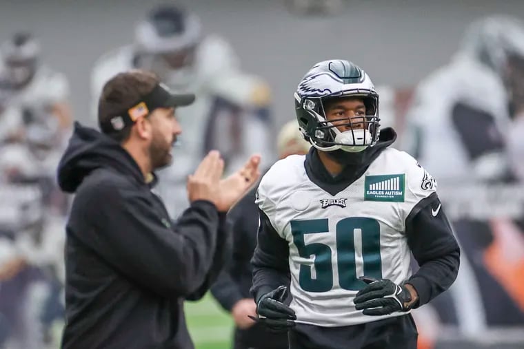 Newly signed Eagles linebacker Shaquille Leonard (50) runs by while Eagles head coach Nick Sirianni claps during practice at the NovaCare Complex in Philadelphia on Thursday, Dec. 7, 2023. Eagles will face the Dallas Cowboys in Arlington on Sunday evening.