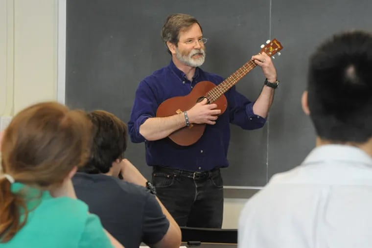 Walter Smith, Haverford College physics professor, sings and plays the baritone ukulele for a class. (Clem Murray / Staff Photographer)