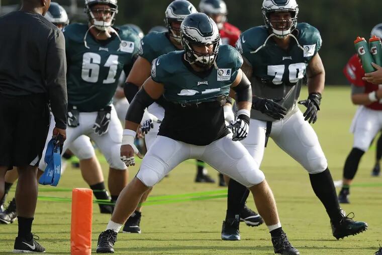Jason Kelce (center) warms up with teammates during training camp on Aug. 3.
