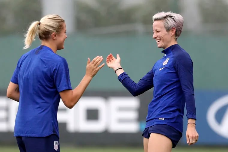 U.S. women's soccer team players Abby Dahlkemper (left) and Megan Rapinoe share a laugh during a training session on Monday.