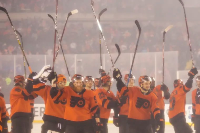 The Flyers raised their sticks after a dramatic late comeback spurred a 4-3 overtime win over the Pittsburgh Penguins during the Stadium Series game at Lincoln Financial Field last Feb. 23. The teams will meet Tuesday at the Wells Fargo Center.