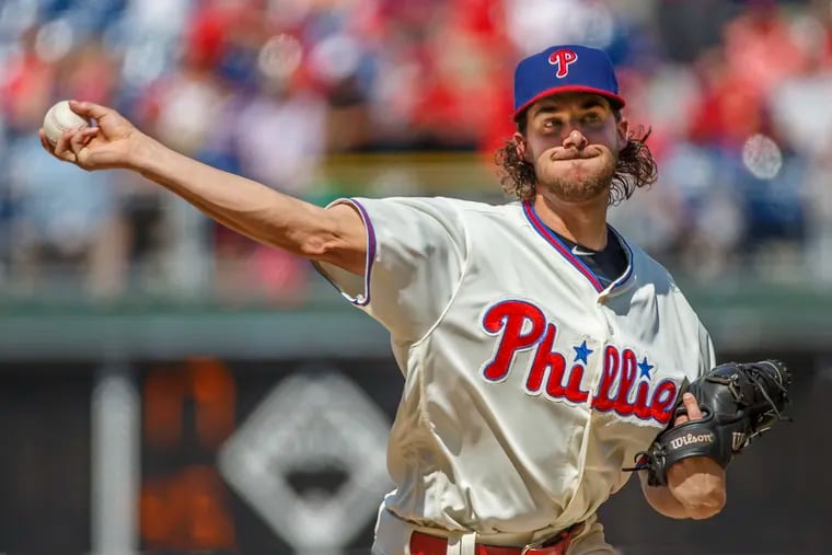 Phillies pitcher Aaron Nola bears down on the Cubs batters in the top of the fifth inning on Sunday.