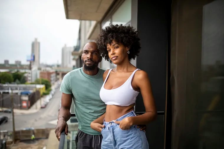 Maleek Jackson, 34, and Raelia Lewis, 30, at their apartment at The Piazza in Northern Liberties. Jackson runs a boxing gym in the neighborhood. Lewis is a model and owner of the online swimwear boutique Waves Swim.