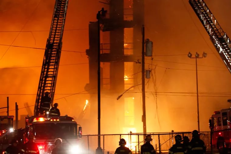 Firefighters battle a five-alarm fire in a warehouse on York Street near Kensington Ave. in the Kensington section of Philadelphia on Monday April 9, 2012.  (For the Daily News/ Joseph Kaczmarek, file)