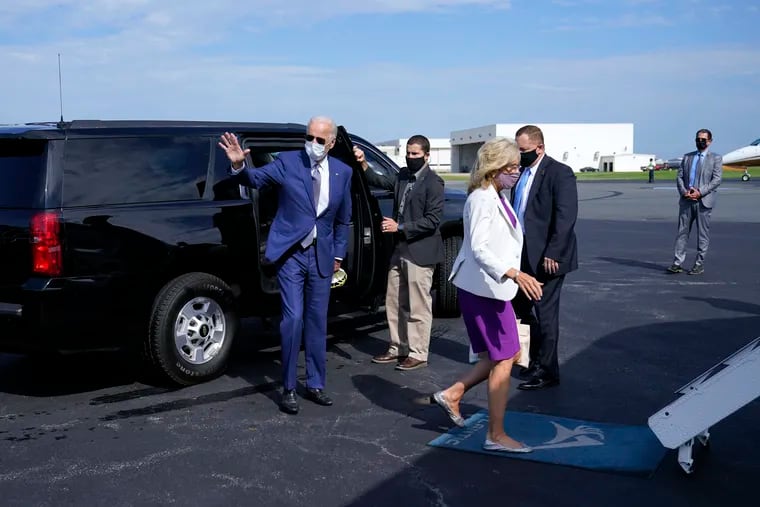 Democratic presidential candidate Joe Biden (waving), and his wife, Jill Biden, walk to board a plane at New Castle Airport, in New Castle, Del., on Thursday, en route to Kenosha, Wis.