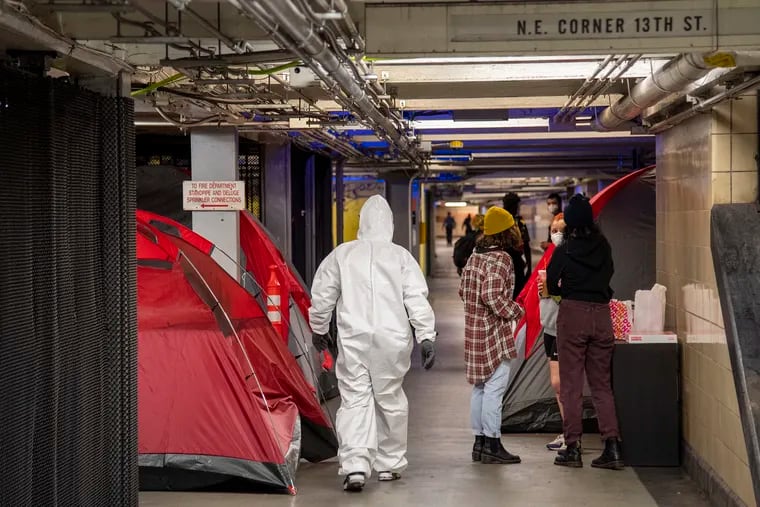 City workers clean a homeless encampment in PATCO station underground at Locust and 13th Streets. Encampment occupants were permitted to stay once the clean-up was done.