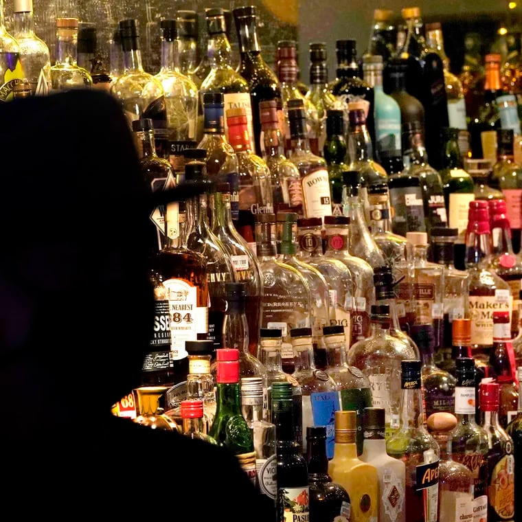 FILE - Bottles of alcohol sit on shelves at a bar in Houston on June 23, 2020. Moderate drinking was once thought to have benefits for the heart, but better research methods starting in the 2010s have thrown cold water on that. (AP Photo/David J. Phillip, File)