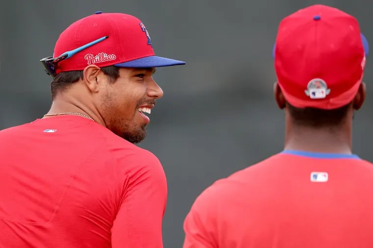 Phillies outfielder Nick Williams, left, laughs as he talks with Andrew McCutchen during a spring-training workout in Clearwater, Fla.