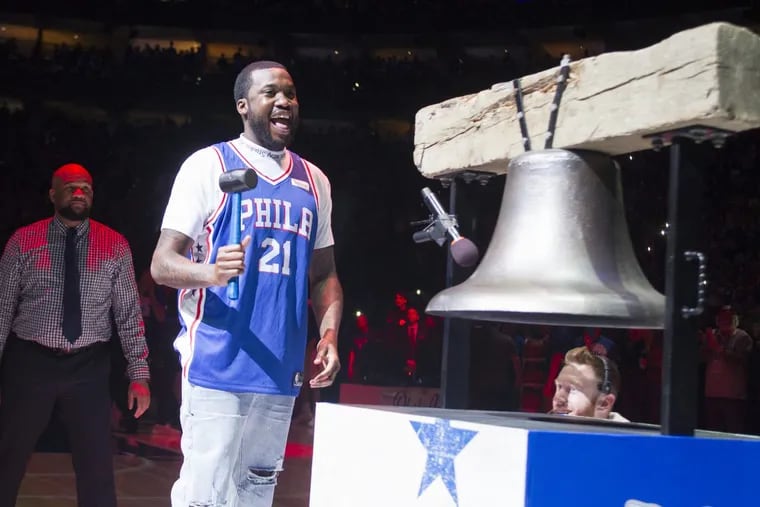 Rapper Meek Mill rings the Liberty Bell replica before the playoff game between the Sixers and the Heat at the Wells Fargo Center after he was released on bail.