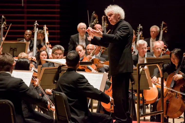 Simon Rattle conducting the Philadelphia Orchestra on Thursday. Pianist Lang Lang was guest soloist. As a curtain-raiser, Rattle used "Unstuck," by composer Andrew Norman. JESSICA GRIFFIN / Staff Photographer