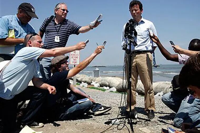 BP CEO Tony Hayward answers reporters' questions on an oil-stained Lousiana beach. (AP Photo / Patrick Semansky)