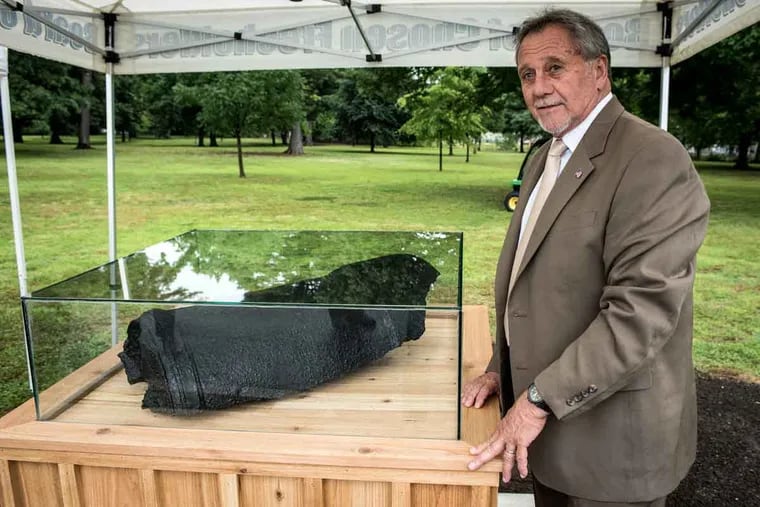 Gloucester County Freeholder Frank DiMarco stands next to a cannon fragment at Red Bank Battlefield Park. He said he hopes the discoveries remind visitors of New Jersey’s crucial role in the American Revolution.