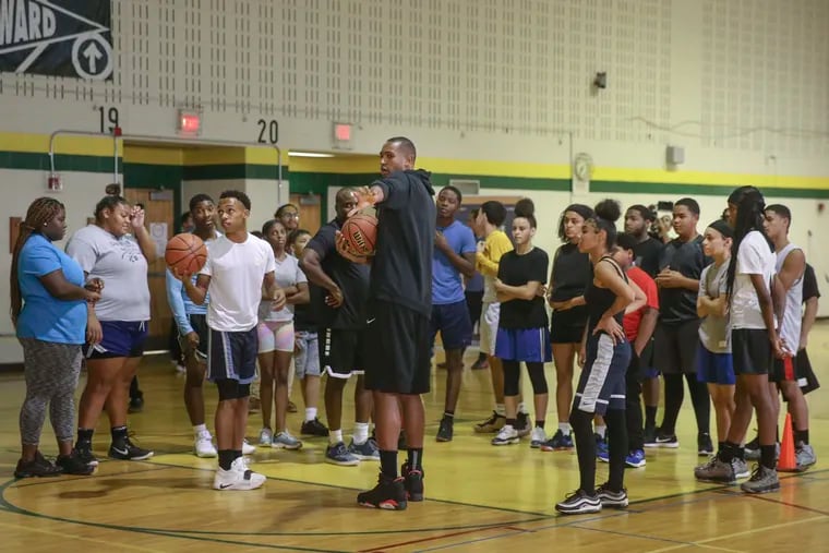 The Sixers' Al Horford works with students from Edison High School/John C. Fareira Skills Center during an afternoon clinic on Wednesday.