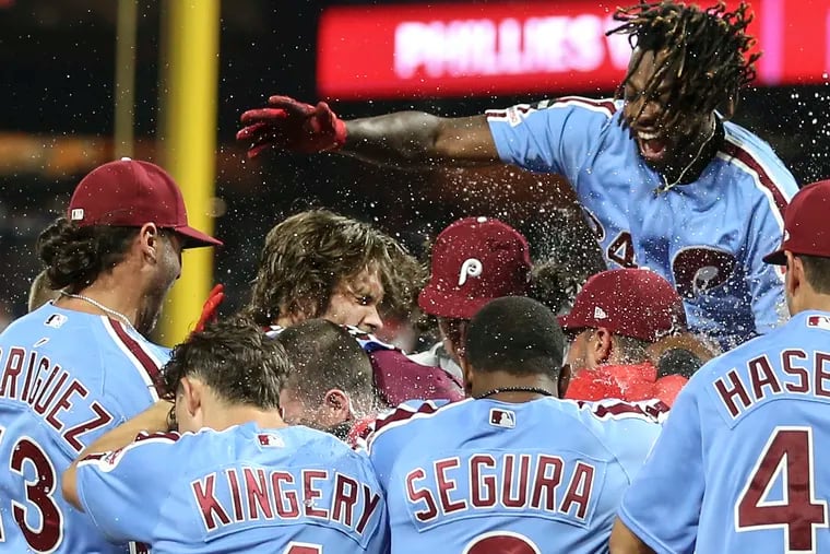 Phillies' Bryce Harper celebrates with teammates after his walkout grand slam to beat the Cubs 7-5 at Citizens Bank Park in Philadelphia, Thursday, August 15, 2019
