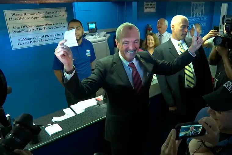 New Jersey Governor Phil Murphy holds the two betting tickets -- both losers -- he placed at Monmouth Park Racetrack last year on the opening day of legal sports betting. He bet on the New Jersey Devils to win the Stanley Cup, and Germany to win the World Cup of soccer.