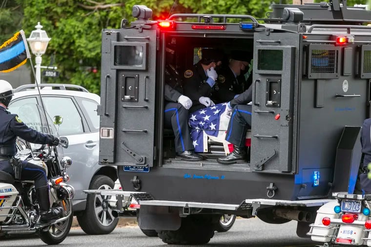 Pallbearers in the back of the armored vehicle used by SWAT officers, was named after Cpl. James Connor. This vehicle is in route to the cemetery after funeral mass ended. The funeral for slain Philly Police Cpl. James O'Connor IV at Our Lady of Calvary Church on Friday morning.