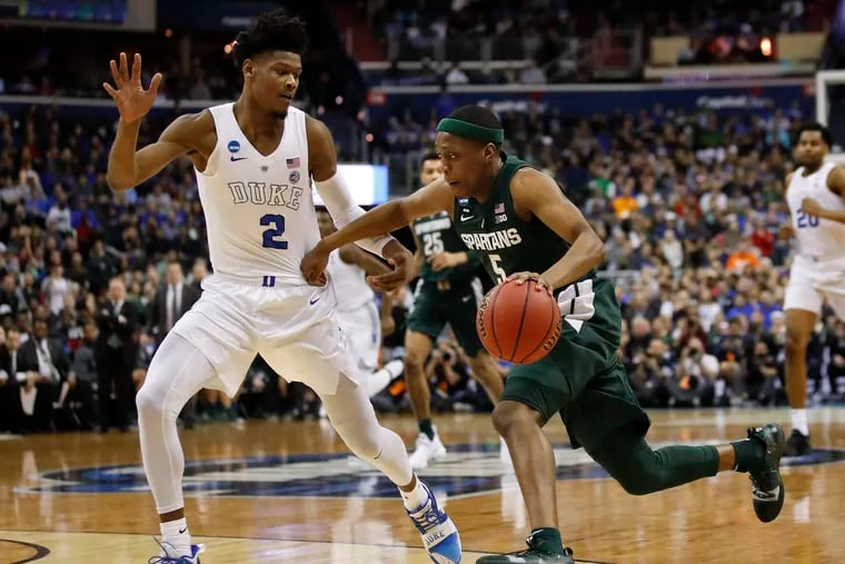 Cassius Winston drives past Duke's Cam Reddish during the first half of the Spartans' win on Sunday.