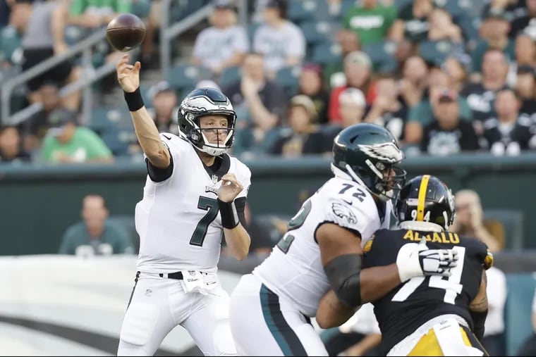 Eagles quarterback Nate Sudfeld throws the football as offensive tackle Halapoulivaati Vaitai blocks Steelers defensive end Tyson Alualu during the first quarter of the Eagles' 31-14 preseason loss on Thursday.