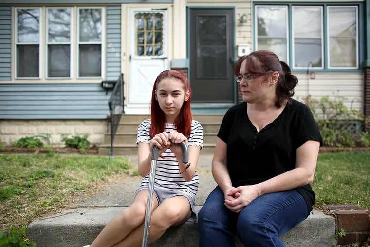 Alexa McClintic, 11, poses for a photograph with her mother Colleen Scanlish-McClintic at her side on May 2, 2015, outside their home in Collingswood, N.J.  ( The Inquirer/ Joseph Kaczmarek )