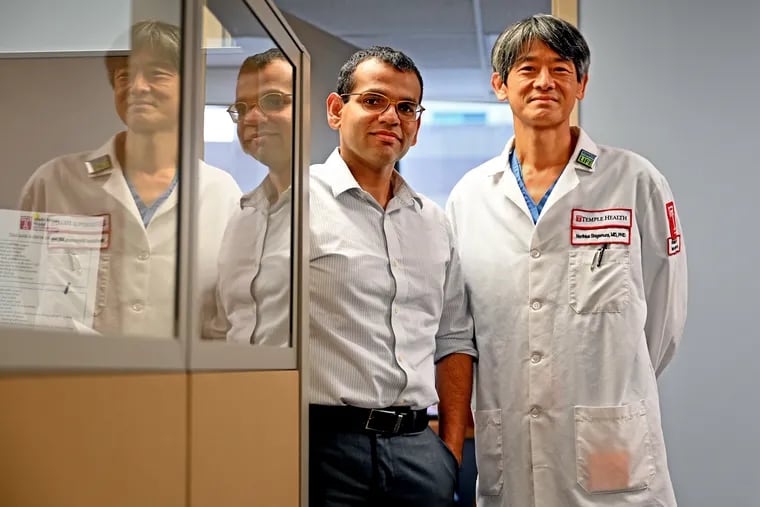Sameep Sehgal (left), a pulmonologist and Norihisa Shigemura (right), a surgeon, pose at Temple University HospitalJuly 21, 2021. The Philadelphia doctors have been treating COVID-19 patients who need lung transplants