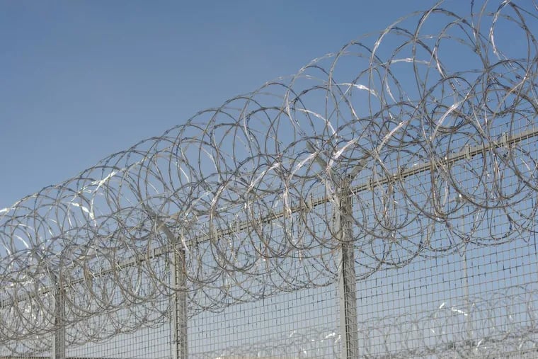 Barbed wire fencing at a prison in Pennsylvania. (WILLIAM THOMAS CAIN / For The Philadelphia Inquirer)