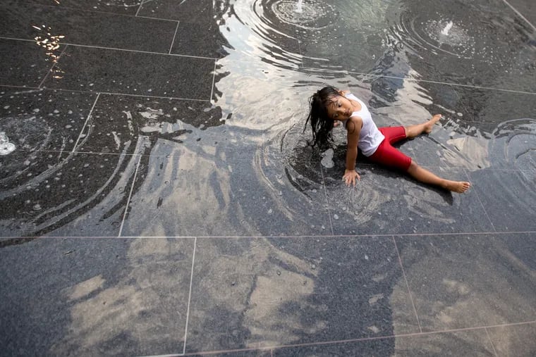 Kimberly Theo, then 4, sits in the fountain at Dillworth Plaza during a hot day in  2016.