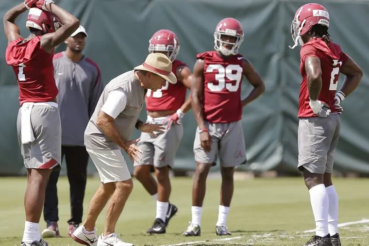 Alabama head coach Nick Saban demonstrates drills to his players during an NCAA college football practice, Thursday, Aug. 3, 2017, in Tuscaloosa, Ala. (AP Photo/Brynn Anderson)