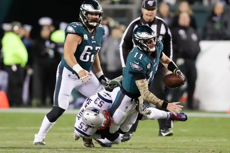Eagles quarterback Carson Wentz getting sacked by the Patriots' Kyle Van Noy in last week's 17-10 loss. He was sacked a season-high five times.