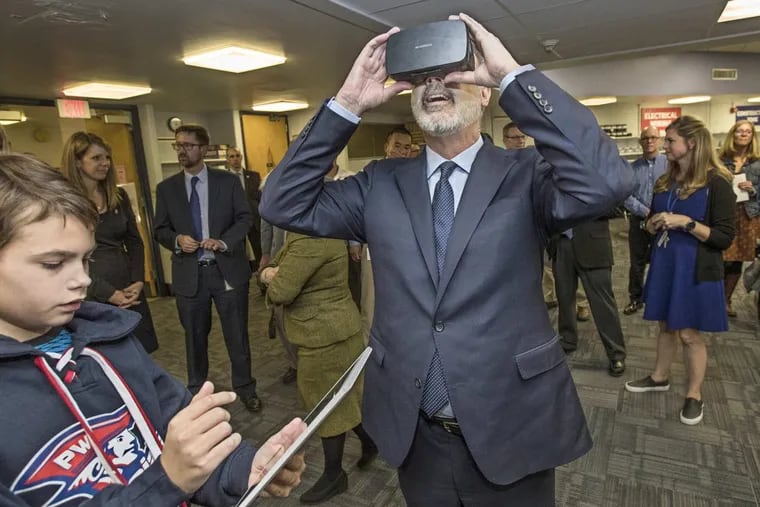 Gov. Wolf, center, takes a virtual tour of the Great Barrier Reef courtesy of Colin McGrain, 13, left, an eighth grader at Colonial Middle School in Plymouth Meeting, Pennsylvania. Wolf on Wednesday announced a shift in the time when state standardized tests would be administered to hundreds of thousands of children across the state.