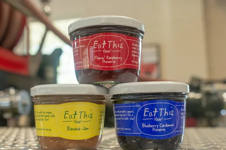 Some of the jam flavors made by Belgian immigrant and volunteer firefighter Gino De Schrijver rest on a firetruck in the firehouse in Erwinna, Pennsylvania in 2018. His side hustle got a jump when his jams got picked up by Whole Foods. In 2014, Oprah featured the jams in her magazine. Now the side hustle is bigger. WILLIAM THOMAS CAIN / For The Inquirer