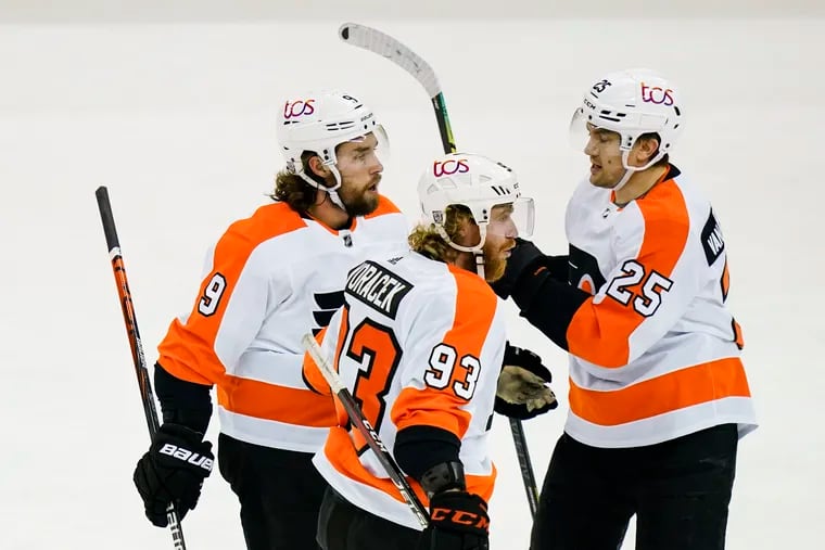 The Flyers' Ivan Provorov (9), Jake Voracek (93) and James van Riemsdyk (25) celebrate after van Riemsdyk scored a first-period goal Tuesday against the host New Jersey Devils.