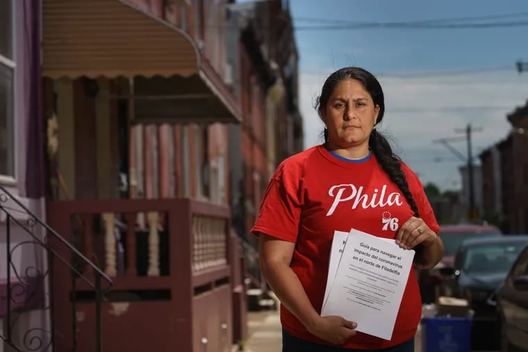 Charito Morales, shown here near 5th and Huntingdon Streets, in Philadelphia on Wednesday. Morales puts Spanish-language and English language pamphlets in food boxes to help people navigate COVID-19.