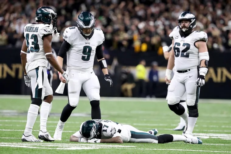 Nick Foles (center) looks down as Alshon Jeffery lays on the turf after missing a crucial late-game pass.