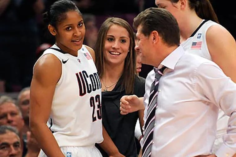 Maya Moore, Geno Auriemma and Connecticut continue to dominate women's basketball. (Henry Ray Abrams/AP)