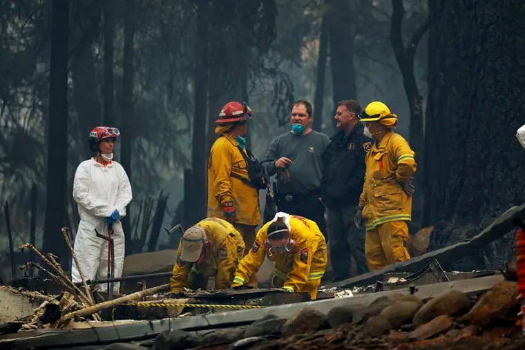 A forensic team investigates the site of a home where remains were found from the Camp fire in Paradise, Calif.