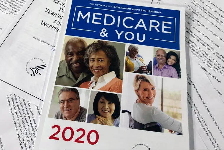 In this Feb. 13 photo, the official U.S. Government Medicare Handbook for 2020 over pages of a Department of Health and Human Services, Office of the Inspector General report, are shown in Washington.