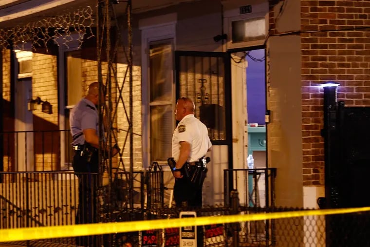 Philadelphia Officers investigate a multiple shooting at a home along the 4500 block of Mulberry Street in the Frankford section of Philadelphia on Sunday.