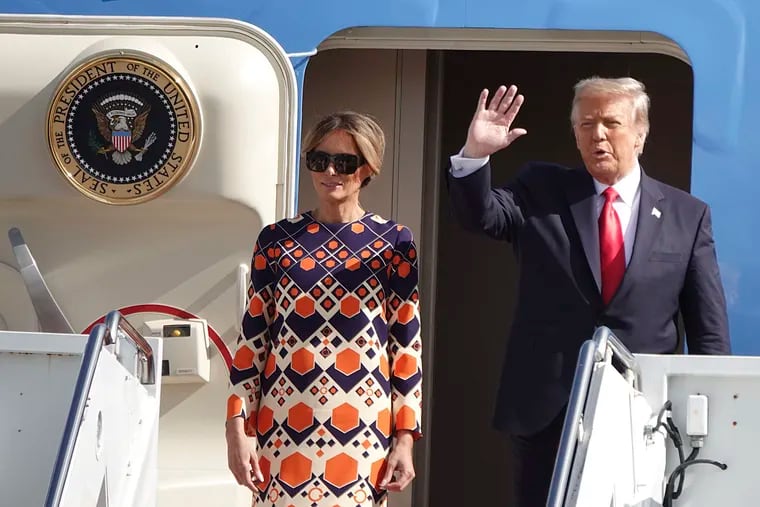 President Donald Trump waves to a handful of supporters as he arrives with First Lady Melania Trump at Palm Beach International Airport in West Palm Beach, on Wednesday, Jan 20, 2021.