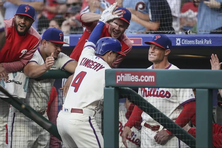 Phillies manager Gabe Kapler and others greet Scott Kingery in the dugout after his three-run homer against the Rockies during the first inning Tuesday night.