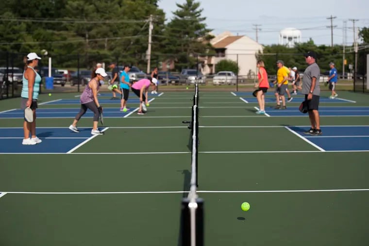 People play pickleball, a popular sport that's a cross between tennis, badminton and ping pong, at DeCou Park in Cherry Hill, NJ, on the afternoon of Monday, June 25, 2018.