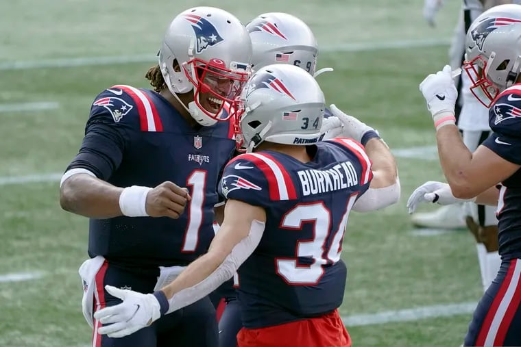 New England Patriots quarterback Cam Newton (1) celebrates his touchdown pass to running back Rex Burkhead (34) in the first half of an NFL football game against the Las Vegas Raiders, Sunday, Sept. 27, 2020, in Foxborough, Mass.