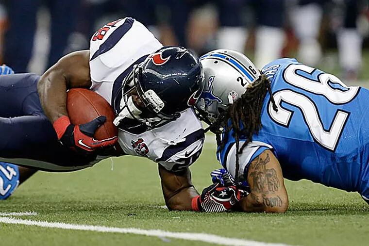 Houston Texans running back Justin Forsett (28) is hit by Detroit
Lions free safety Louis Delmas in Texans territory. Forsett scored a touchdown on this play. (Paul Sancya/AP)